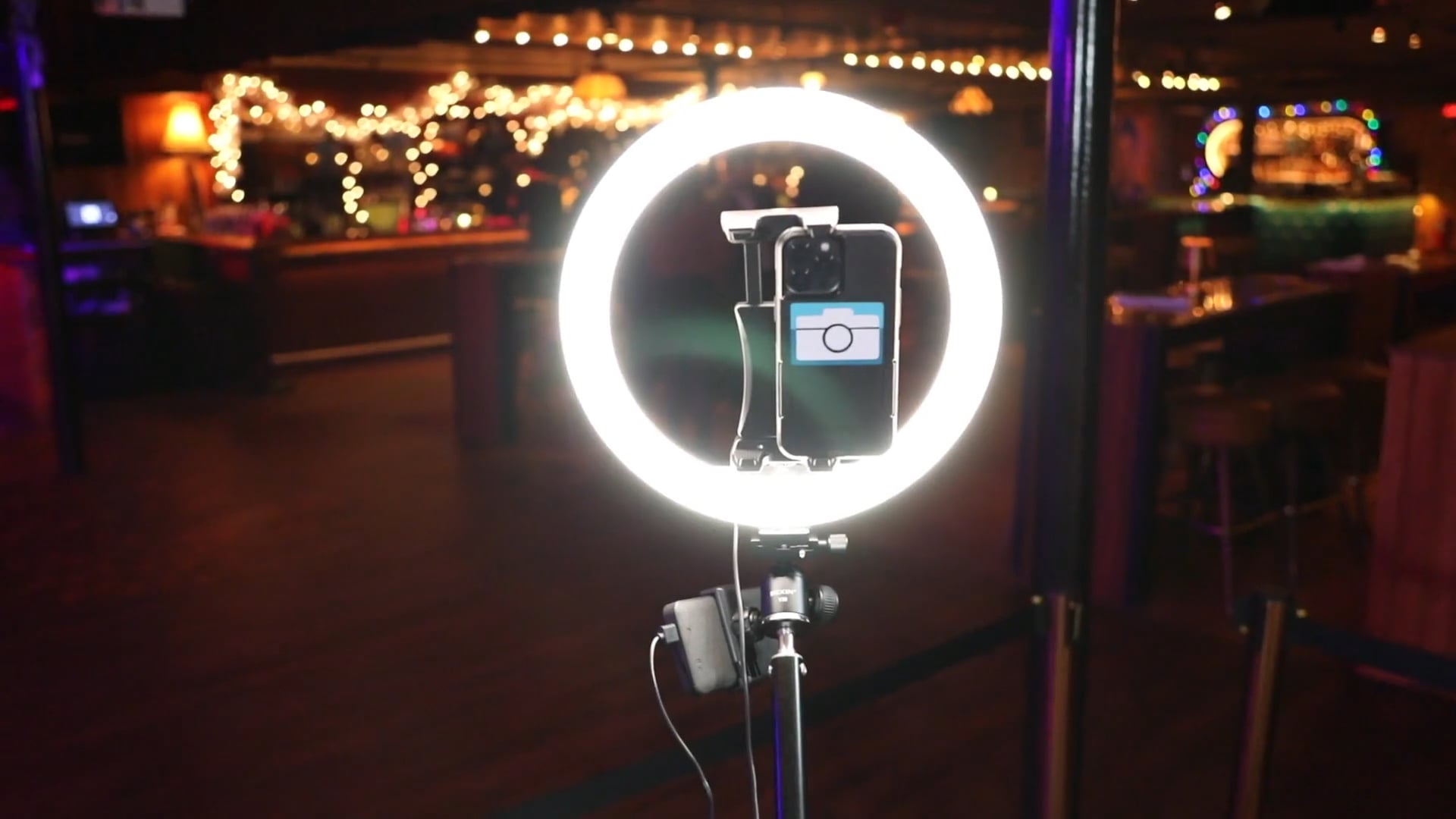 The 360 video booth ring light and camera arm set up on a venue floor