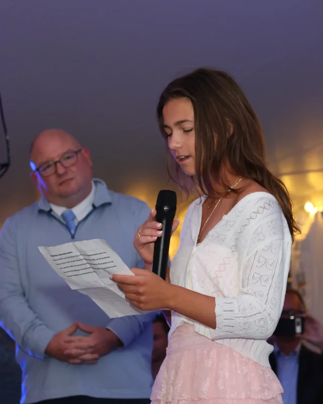 Student speaking on stage at a school ceremony