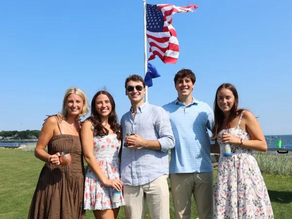 Group of guests photographed together outdoors at a staged event photo op