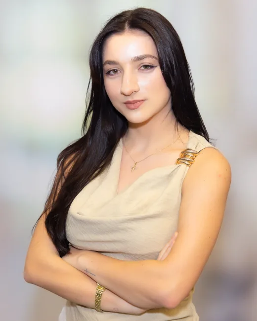 Business headshot of a woman with a clean blurred office background