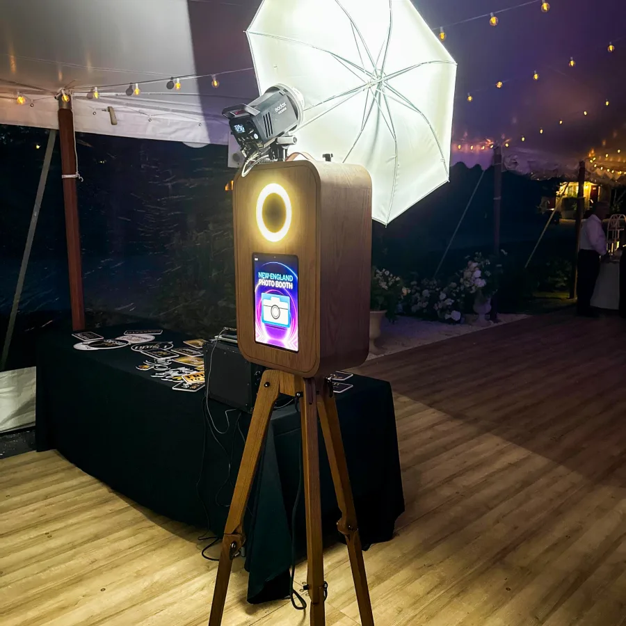 Flashback booth under a tent with string lights at a night wedding