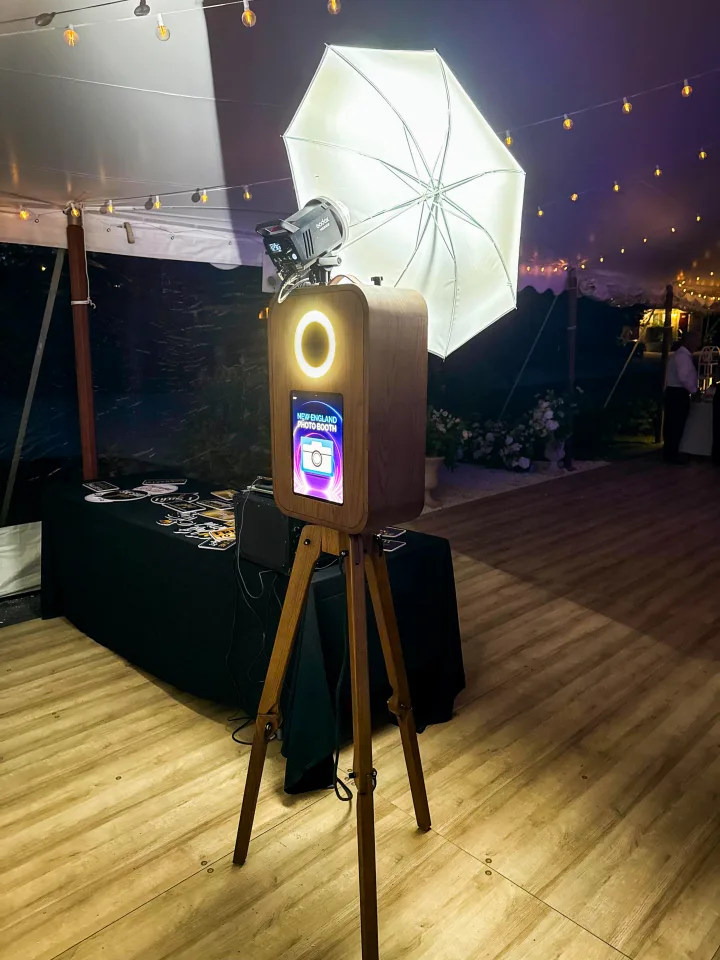 Flashback booth under a tent with string lights at a night wedding
