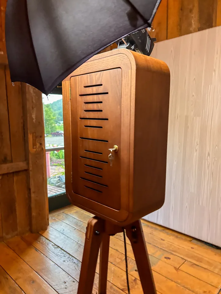 Close-up of the Flashback booth red oak wood finish and brass lock