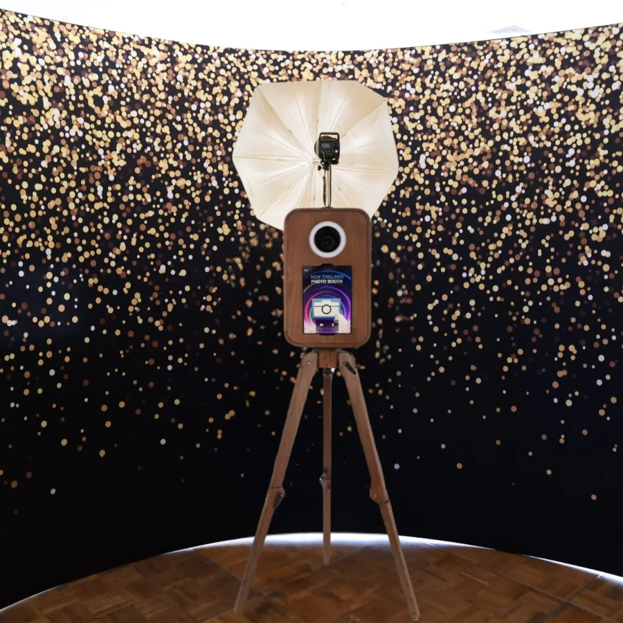 Flashback booth in front of a gold confetti backdrop