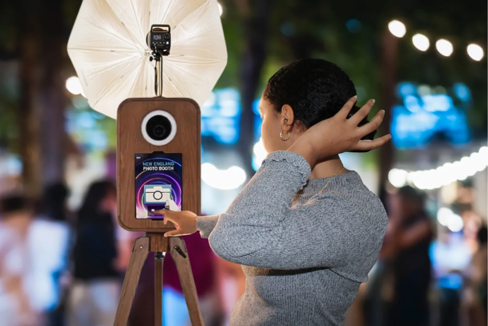 Guest using the Flashback booth touchscreen at an evening event