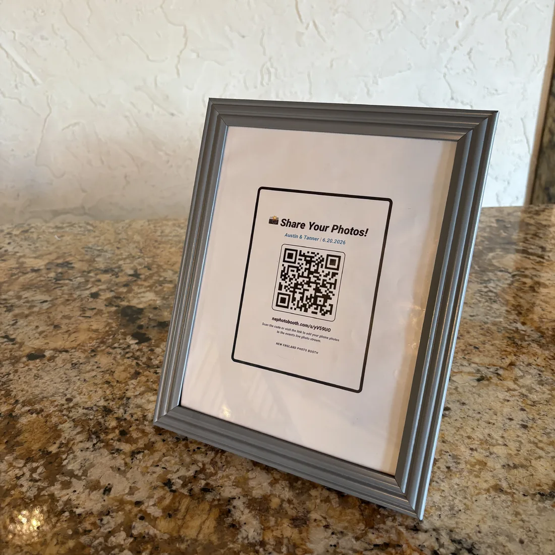 Framed GuestView QR table sign on a reception table