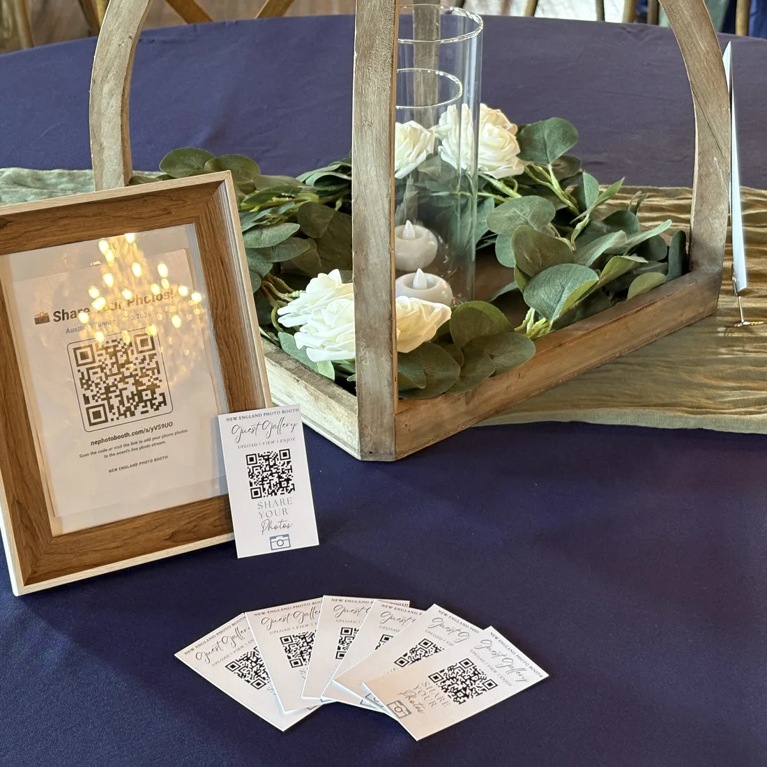GuestView QR sign and Guest Gallery cards styled on a wedding tablescape with floral centerpiece