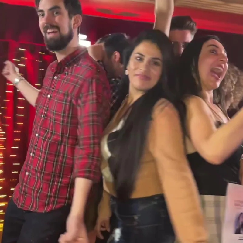 Guests laughing through a take together, shot by the booth camera