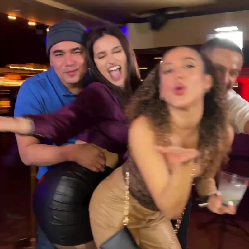 Friends piling in for a group take, shot by the booth camera