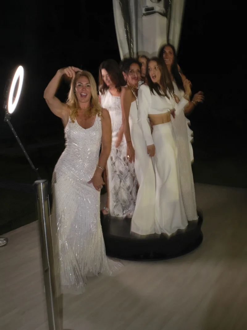Guests posing on the 360 video booth platform mid-spin