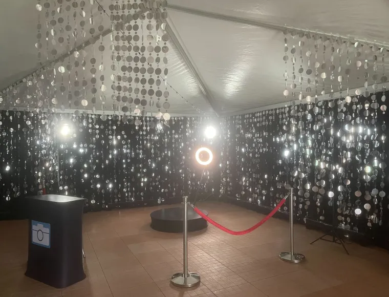 360 booth inside a silver sequin curtain room with rope stanchions