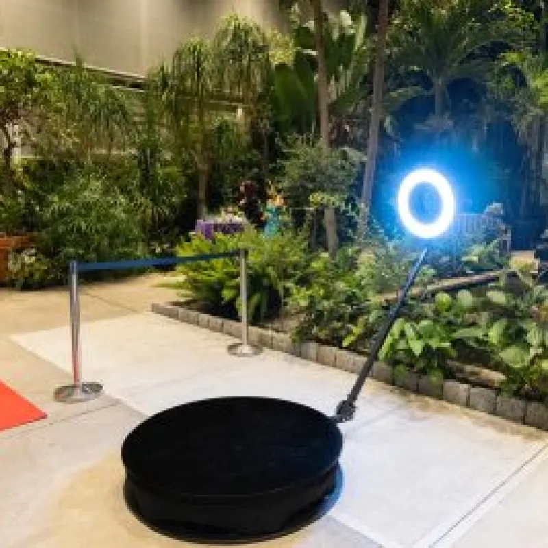 The 360 booth and red carpet set up in a lush conservatory at night