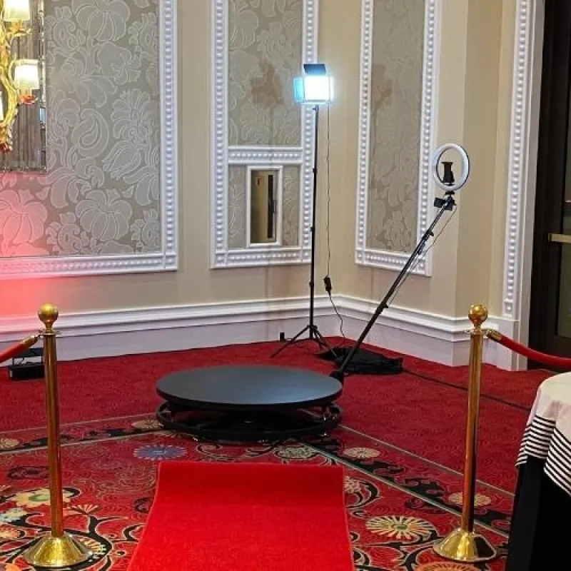 The 360 booth on a red carpet with gold stanchions in an ornate ballroom