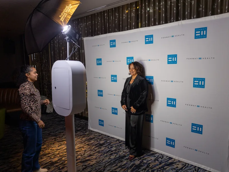 Guests using the LuxPod photo booth at a corporate event