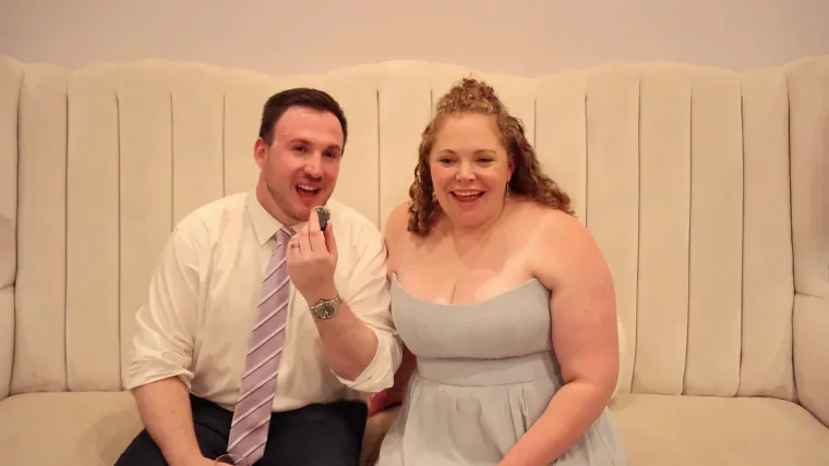 Bride in a light blue gown recording a video message with her guest