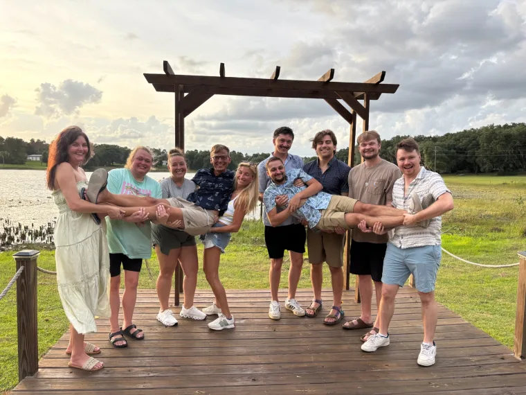 Wedding party posing on a porch at a New England venue