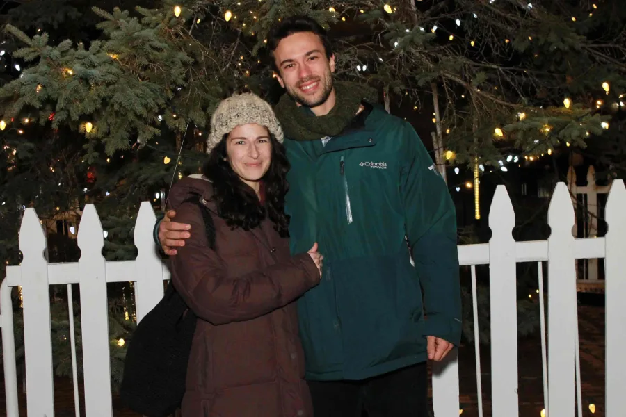 Couple photographed outdoors at a town tree lighting photo op
