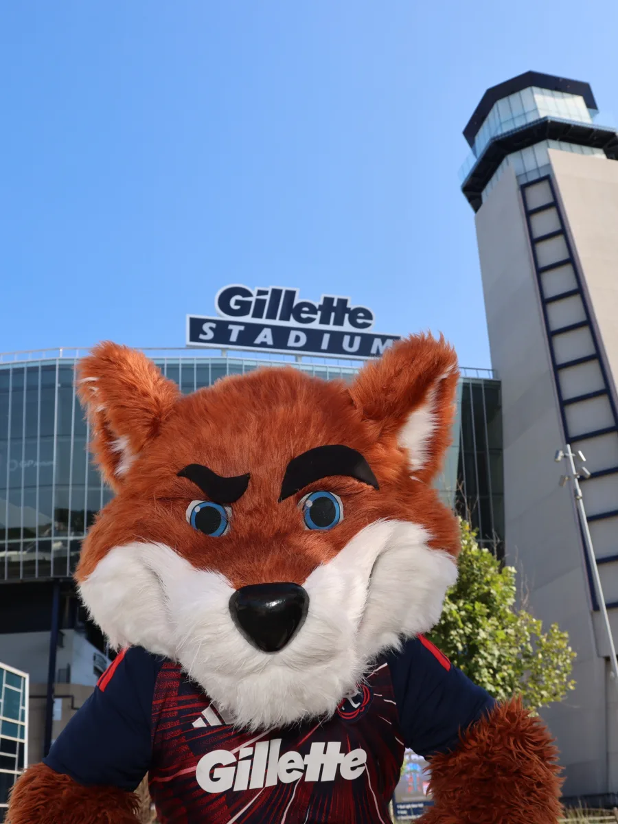 The Gillette mascot posing with guests at a staged photo op outside the stadium