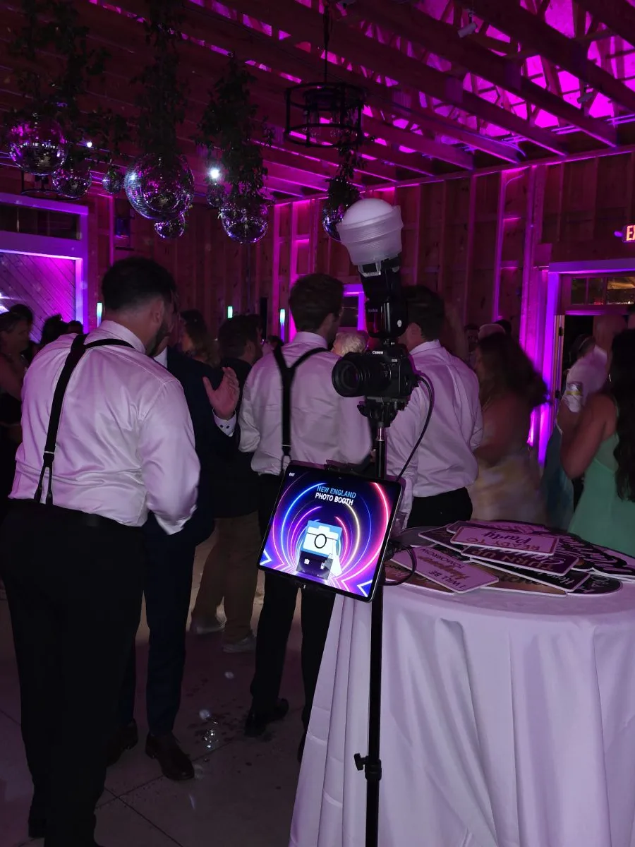 The HD Tripod Pro on the dance floor under magenta uplighting, guests behind it