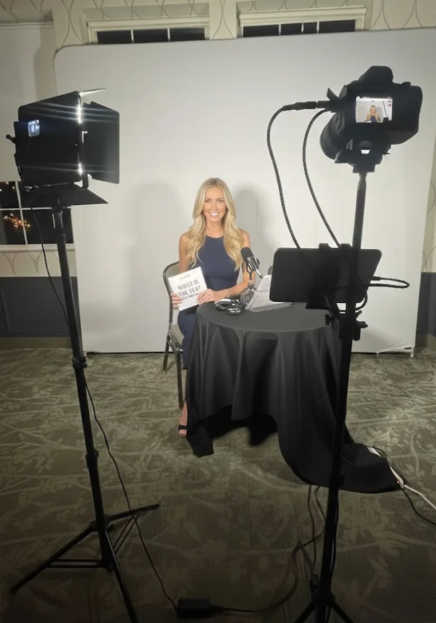 The Confessional video booth set up on site with lighting and a seated guest