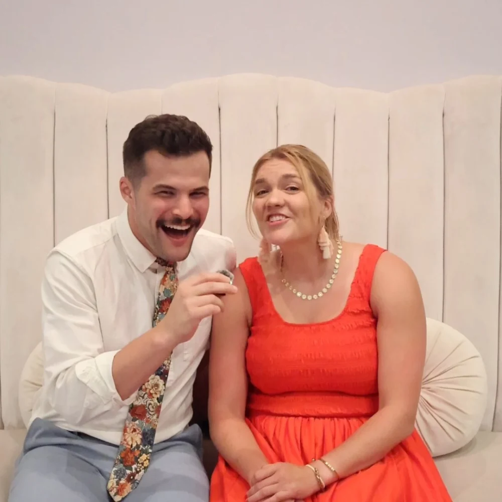 Couple sharing a laugh while recording a Confessional Booth message