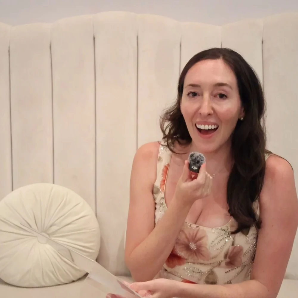 Wedding guest laughing while recording a video message on the lounge