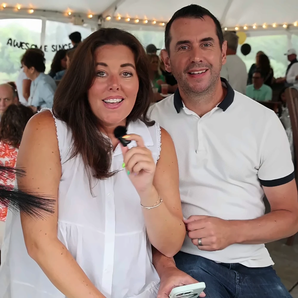 Couple recording a video message together at a reception