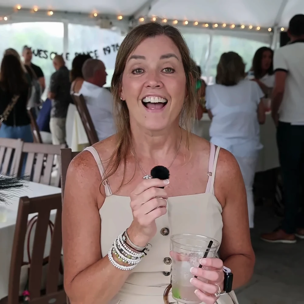 Guest mid-laugh recording a video message at an event