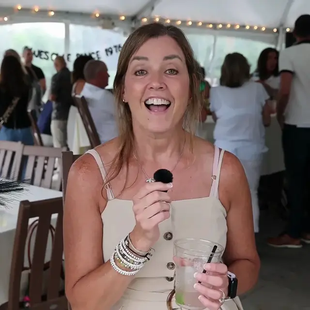Guest mid-laugh recording a video message at an event