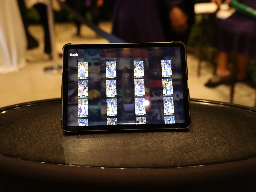 iPad sharing station displaying the event photo gallery at a reception