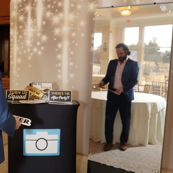 Guest choosing a prop sign at the Mirror Booth