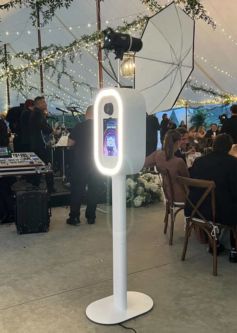 LuxPod photo booth showing touchscreen interface and print output